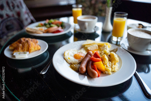 Delicious Breakfast for Two at the Luxury Hotel  Eggs  Sausages  Vegetables  Croissants Coffee  Orange Juice