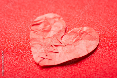 Torn apart paper heart with red stitches. Healing broken heart concept, new love, relationships photo
