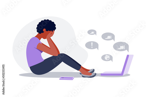 Sad black woman sitting and crying with phone in front of laptop screen  surrounded by message bubbles. Cyber bullying in social networks and online abuse concept. Vector flat cartoon illustration