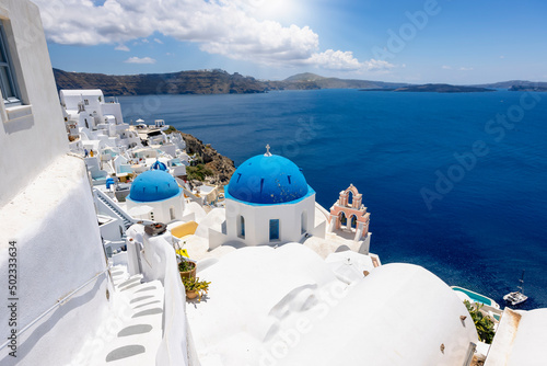 View to the beautiful village of Oia, Santorini island, Greece, with blue domed churches and whitewashed houses