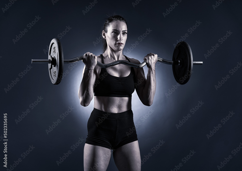 Woman doing barbell biceps curls Woman doing barbell biceps curls