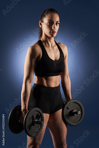 Woman with dumbbells ready for workout