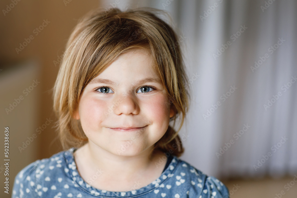 Close-up portrait of a cute little girl. Happy smiling preschool child looking at the camera. Childhood concept. Close-up portrait of a cute little girl. Happy smiling preschool child looking at the camera. Childhood concept.