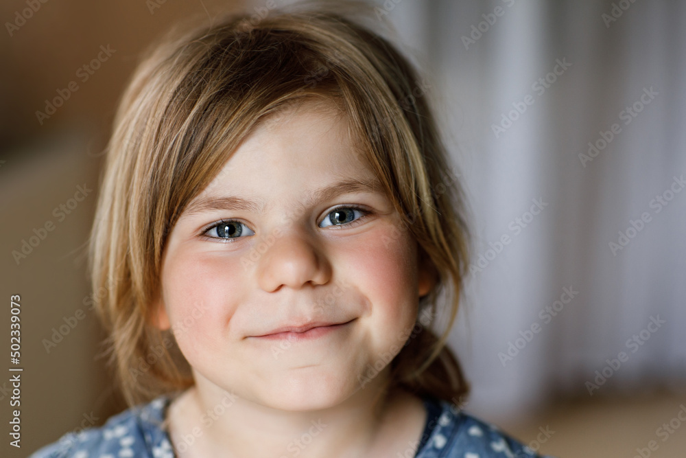 Close-up portrait of a cute little girl. Happy smiling preschool child looking at the camera. Childhood concept. Close-up portrait of a cute little girl. Happy smiling preschool child looking at the camera. Childhood concept.