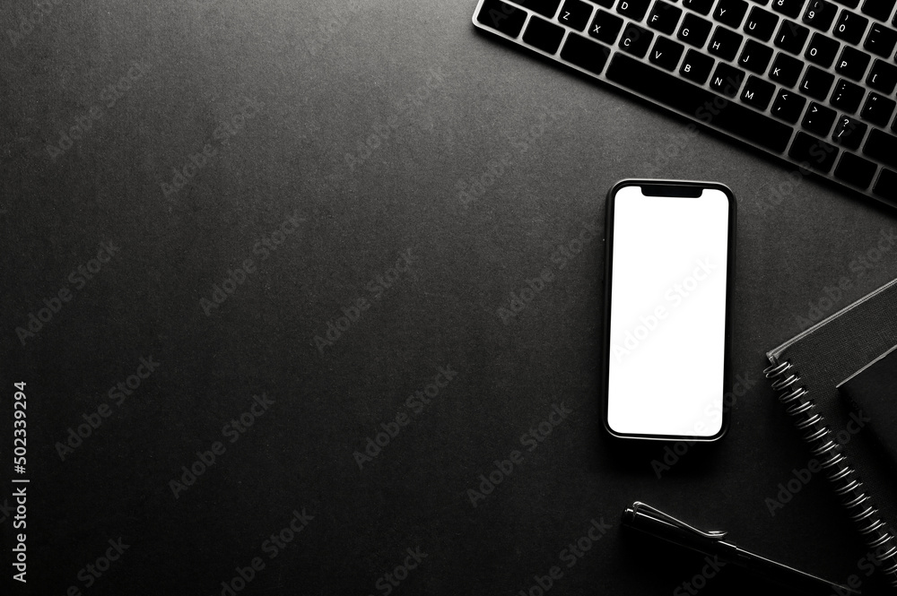Hipster black office table background with copy space and smartphone