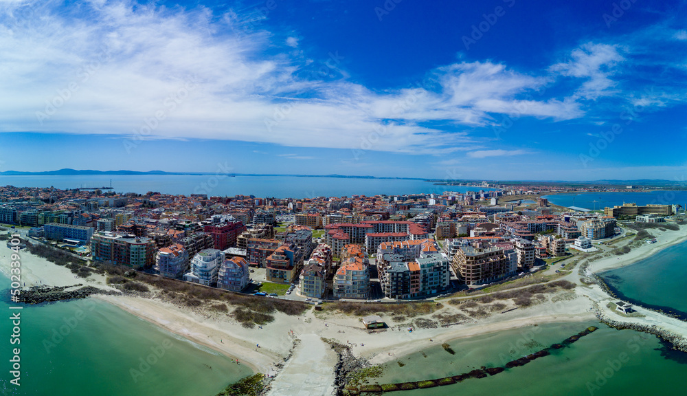 Obraz premium Panoramic view from a height above the town of Pomorie with houses and streets washed by the Black Sea in Bulgaria
