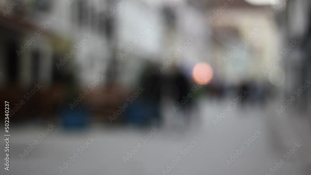 Out of focus, blurred, not recognizable people in town, on streets. Walking. Out of focus, blurred, not recognizable people in town, on streets. Walking.