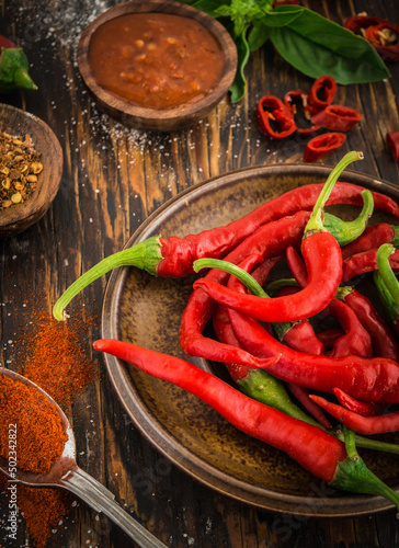 Chili Pepper, Red chili pepper, pepper powder, basil on wooden background