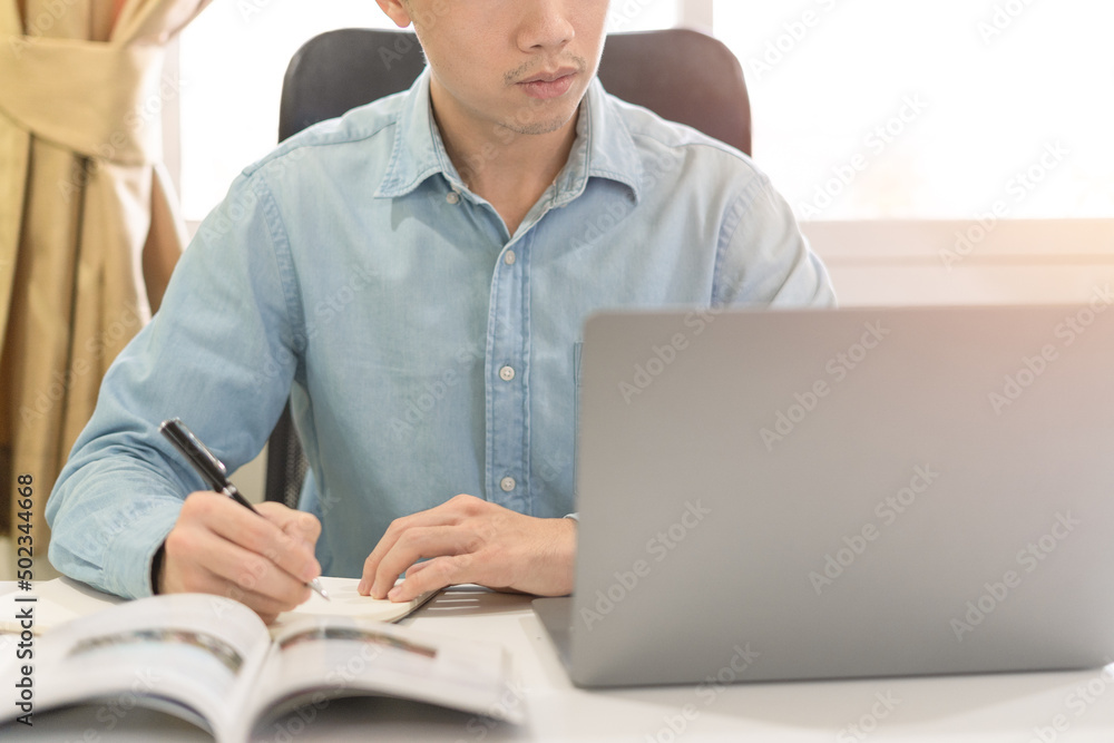 Young businessman or investor learning trading and investing on laptop for stock and Cryptocurrency trading, investing on online Cryptocurrency and stock platform. Young investor investing concept. Young businessman or investor learning trading and investing on laptop for stock and Cryptocurrency trading, investing on online Cryptocurrency and stock platform. Young investor investing concept.