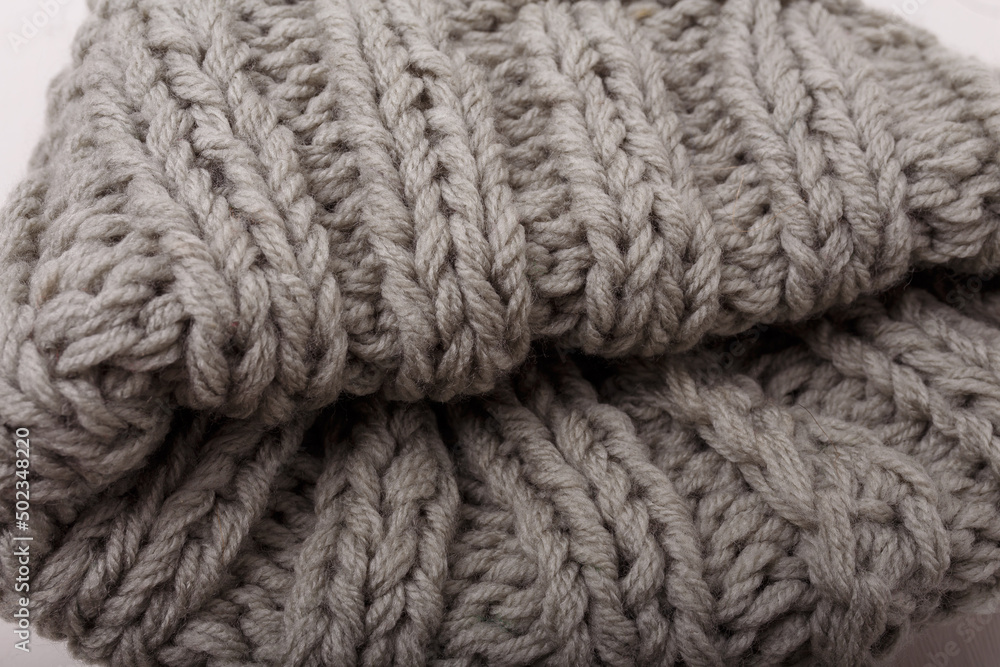 Knit grey fabric texture, background or backdrop. Textile, scarf or sweater textured surface. Warm accessories, clothing, fashion concept. Knit grey fabric texture, background or backdrop. Textile, scarf or sweater textured surface. Warm accessories, clothing, fashion concept.