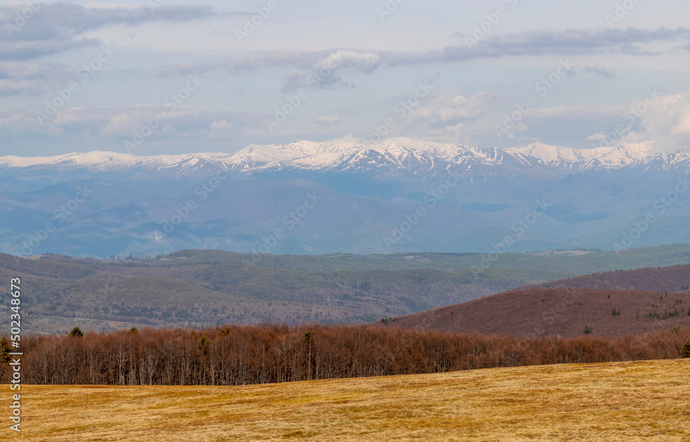 The landscape of distant mountains covered with snow