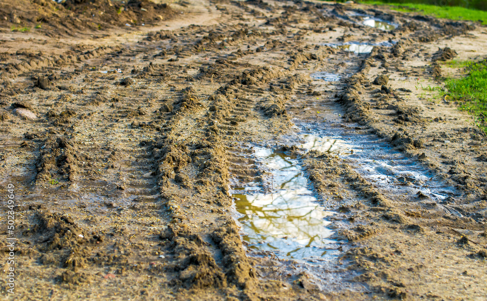 tire tracks in the mud, puddles after rain tire tracks in the mud, puddles after rain