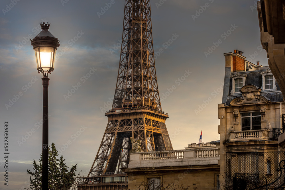 Paris, France - December 11, 2021: Nice view of Eiffel tower with Haussmann building in Paris Paris, France - December 11, 2021: Nice view of Eiffel tower with Haussmann building in Paris