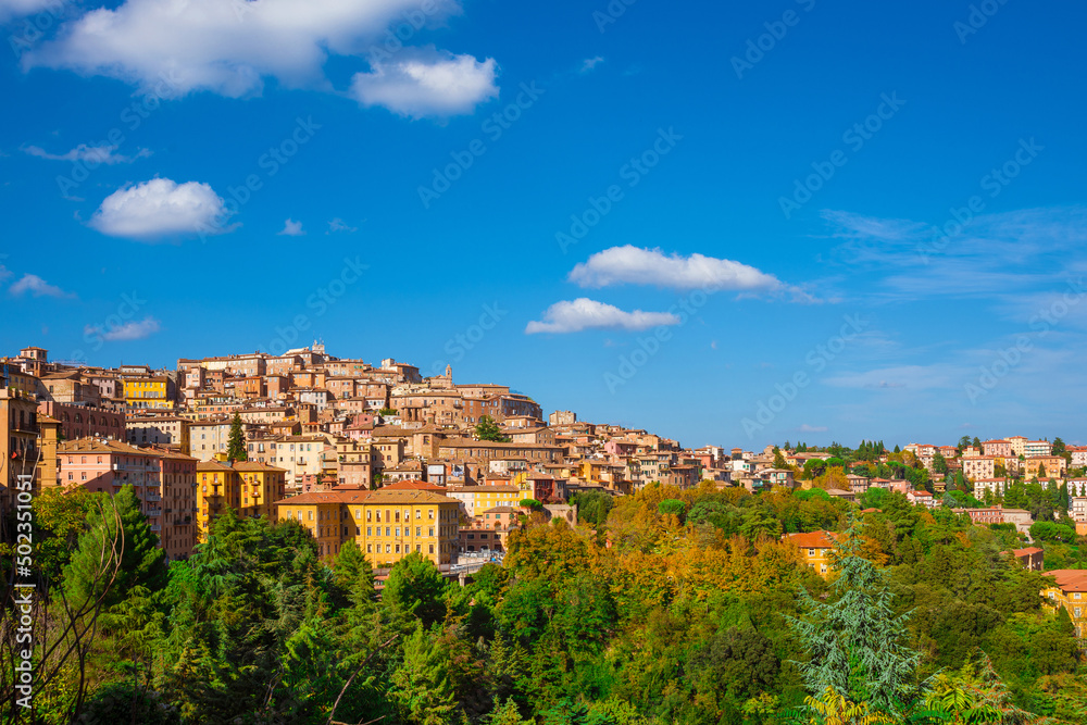 View of Perugia medieval historic center with blue sky and white clouds