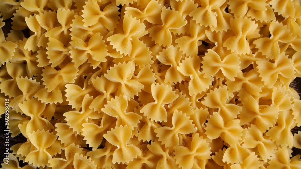 Raw italian bow shaped pasta on rotating table. 4k footage Raw italian bow shaped pasta on rotating table. 4k footage