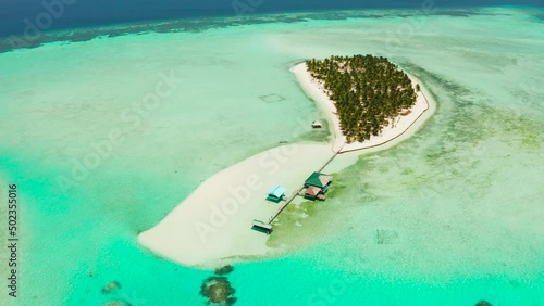 Tropical island with beautiful beach, palm trees and turquoise water view from above. Onok Island, Balabac, Philippines. Summer and travel vacation concept photo