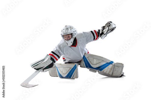 Portrait of teen boy, hockey player, goalkeeper catching plug in motion isolated over white studio background. Training