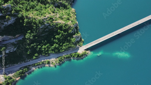 Aerial footage a car driving over a bridge on Piva Lake
