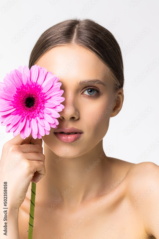 Fototapeta premium Beauty face of young woman with flower. Beauty treatment concept.