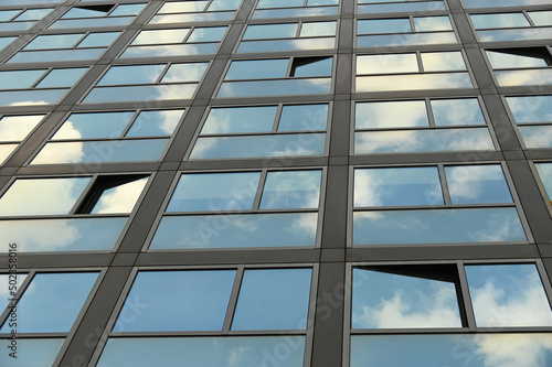 cloudy sky reflection on glass surface of modern building