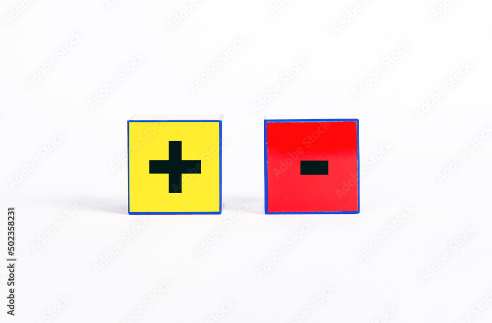 Cubes with plus and minus. Positive and negative features or choice between opposites and differences concept. High quality photo