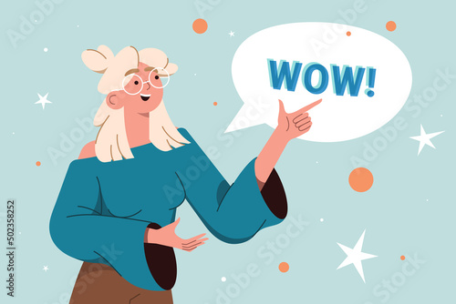 Young blond smile woman points a finger to speech bubble with wow text. Happy teen girl with positive face expression and pointing hand gesture flat vector illustration on blue background.