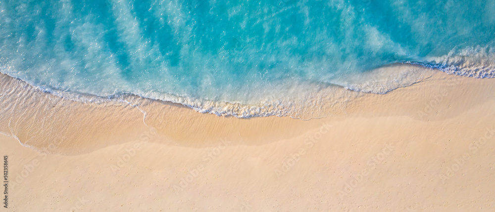 Summer seascape beautiful waves, blue sea water in sunny day. Top view from drone. Sea aerial view, amazing tropical nature background. Beautiful bright sea with waves splashing and beach sand concept - obrazy, fototapety, plakaty 