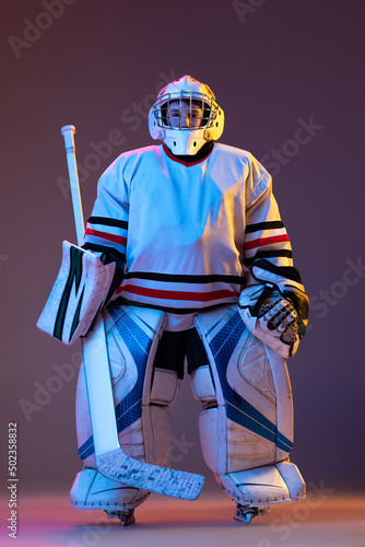 Canvas Print Portrait of boy, child posing in protective hockey uniform of goalkeeper isolate