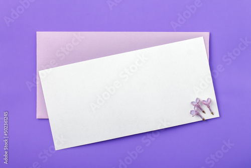 Blank paper card and envelope mockup on trendy very peri background.