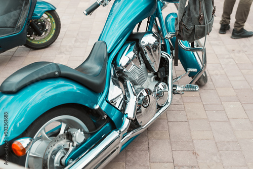 Stylish vintage motorcycle parked outdoors. Close-up of custom bike with shiny chrome details