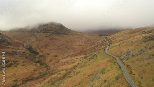 Aerial view of a long road with scenic mountain landscapes in Snowdonia National Park, Wales photo