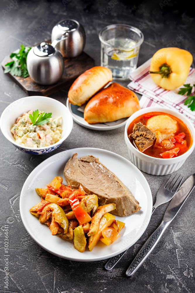 Dinner table with different dishes, three-course set of three courses soup, second course and saladon the table. Three course menu Dinner table with different dishes, three-course set of three courses soup, second course and saladon the table. Three course menu