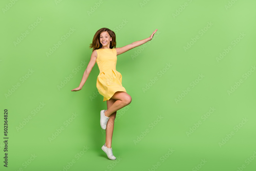 Full size photo of adorable kind sweet little positive female enjoying spring vacation isolated on green color background Full size photo of adorable kind sweet little positive female enjoying spring vacation isolated on green color background