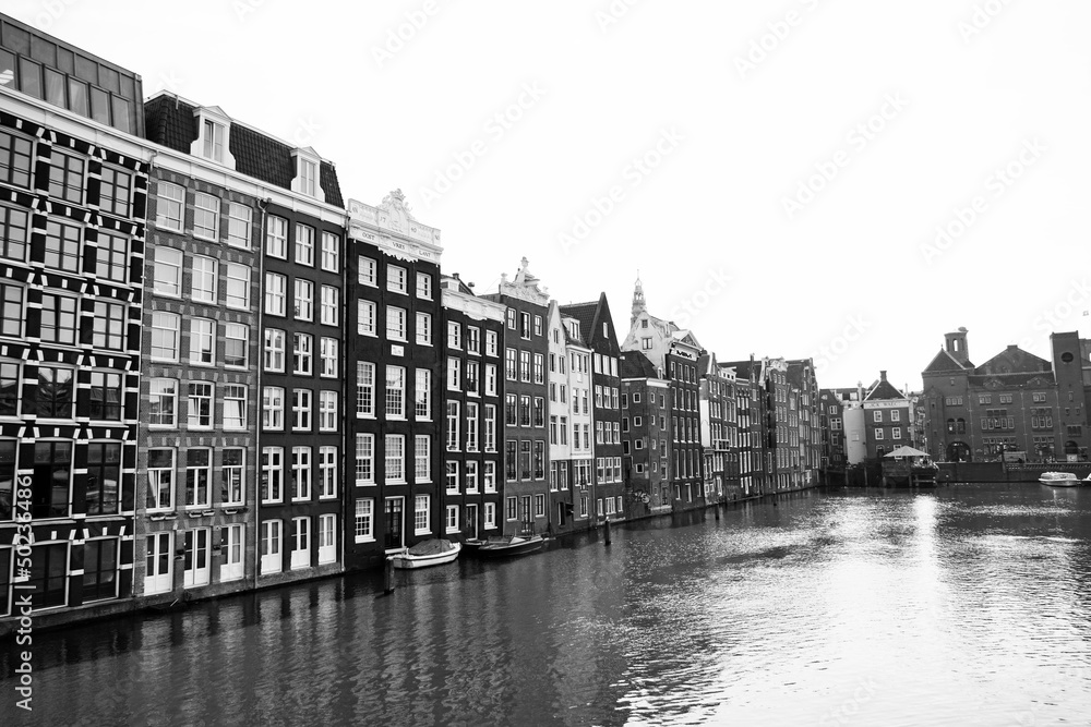 Fototapeta premium Row of houses by the water in the center of Amsterdam, Netherlands. 