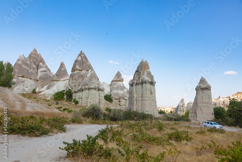 Cappadocia   s landscape includes dramatic expanses of soft volcanic rock  shaped by erosion into towers  cones  valleys  and caves.