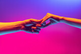 Acquaintance. Male and female hands touching each other on gradient blue and pink background in neon. Concept of human rights, social issues, gathering.