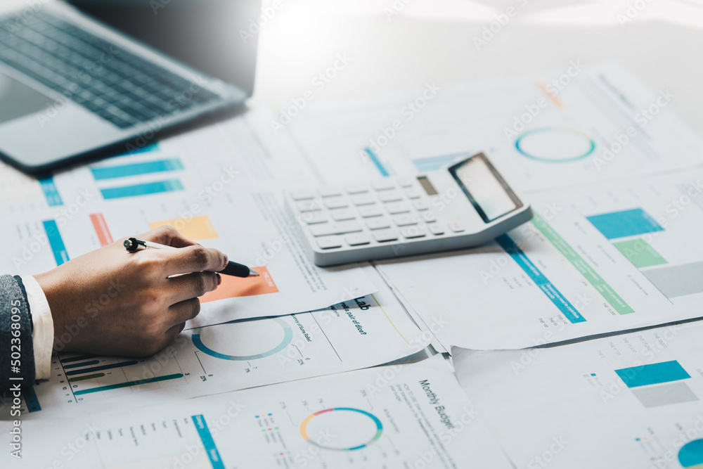 Close up Business woman hand using calculator to calculate the company's financial results and budget. Account Audit Concept. Close up Business woman hand using calculator to calculate the company's financial results and budget. Account Audit Concept.