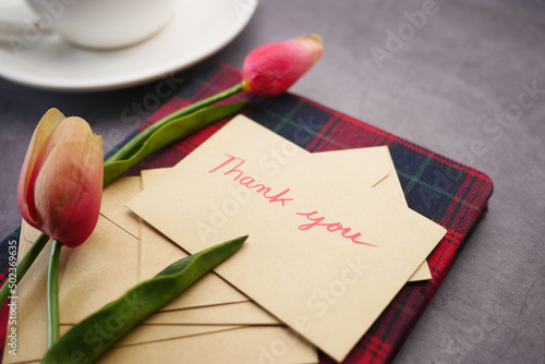 thank you message, envelope tulip flower on table 