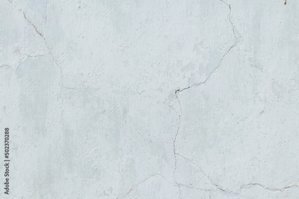 The texture of the cracked wall of the house. Chalk paint peeled off the wall. The texture of the cracked wall of the house. Chalk paint peeled off the wall.