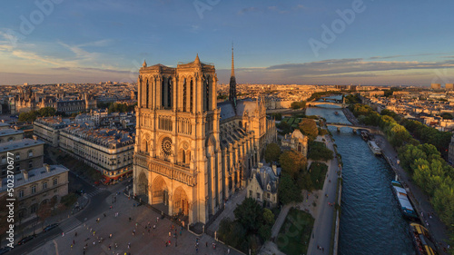Panoramic aerial view of Notre Dame Basilica at sunset in Paris, France.