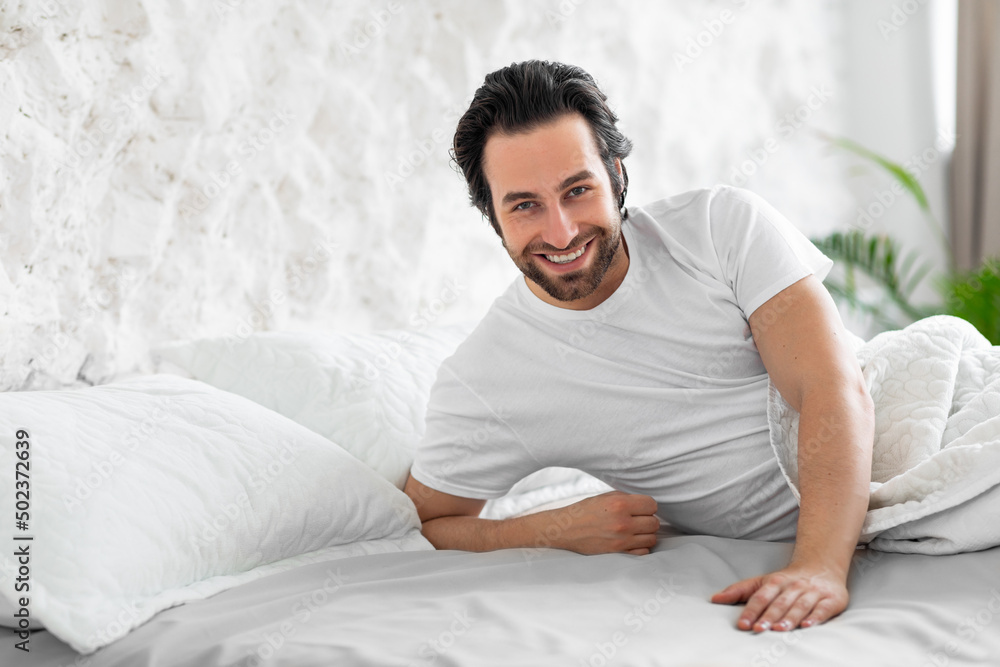 Handsome young man laying in bed, waiting for his lady Handsome young man laying in bed, waiting for his lady