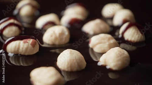 Cake with nuts is poured with chocolate