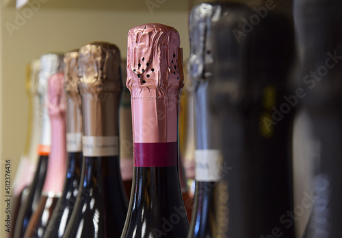 Sparkling wines from different countries are placed on the store shelf.

