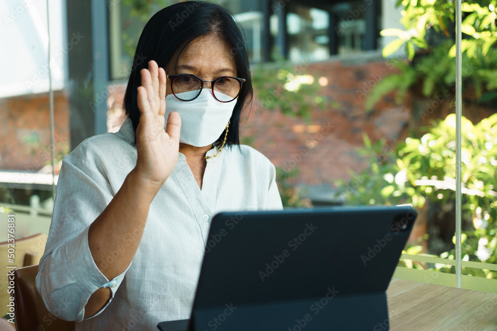 senior woman aged 60-69 years using tablet, watching lesson Sign ...