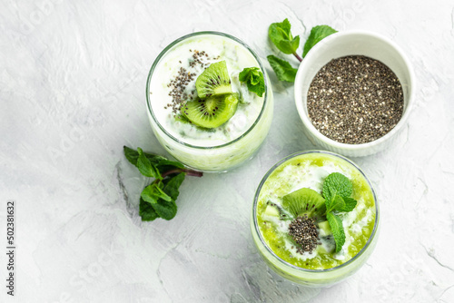 Chia pudding in a glass. Healthy breakfast. chia pudding with kiwi on light background. Long banner format. top view