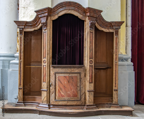 The historical confessional at baroque church. photo