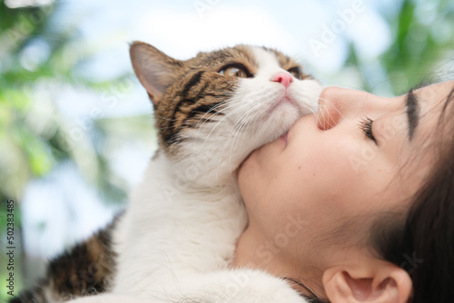 Young Asian woman working from home with her cat