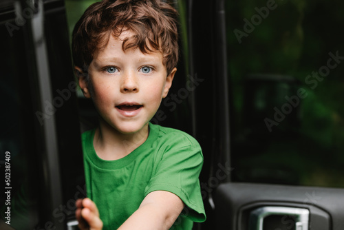 Cute amazed boy in car photo