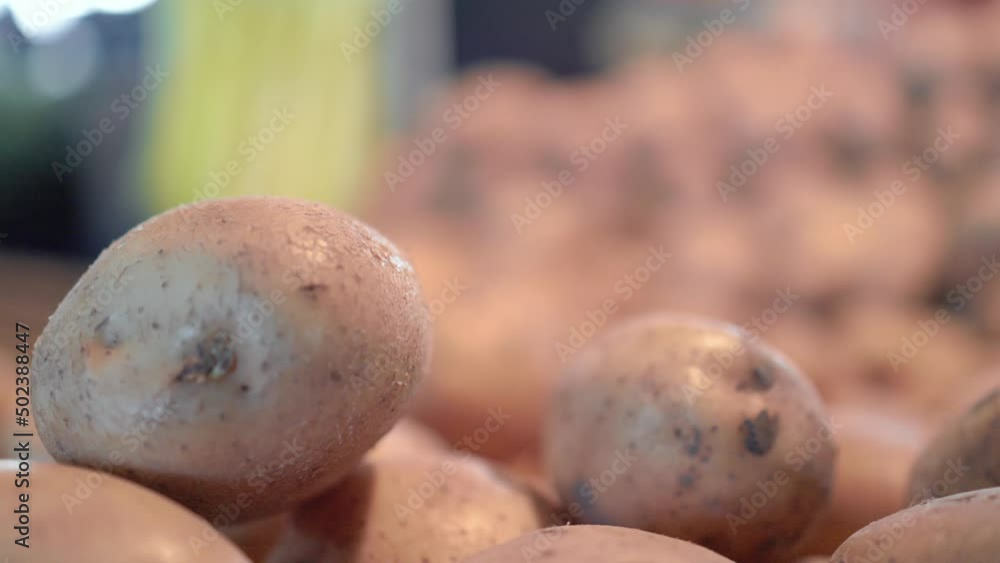 Close up view of potatoes on counter in the farm market. Slow motion Close up view of potatoes on counter in the farm market. Slow motion