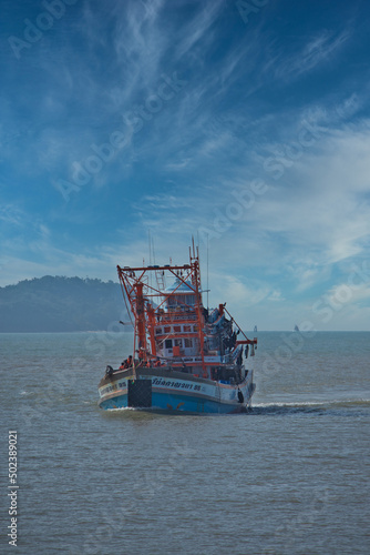 Beautiful shot of a boat in a sea under the cloudy skies in Ratsada Bay , Thailand photo